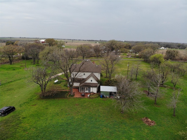 birds eye view of property with a rural view