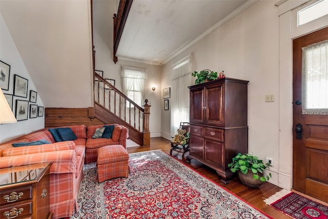 living room featuring wood-type flooring and ornamental molding