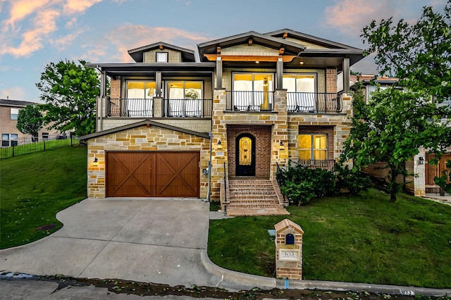 view of front of property with a yard, a balcony, and a garage