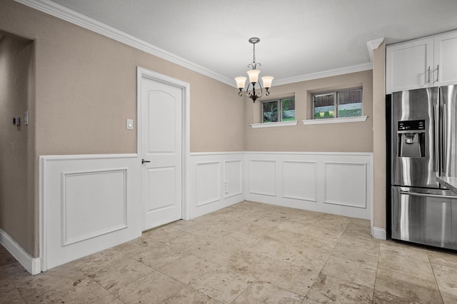 unfurnished dining area with a notable chandelier and crown molding