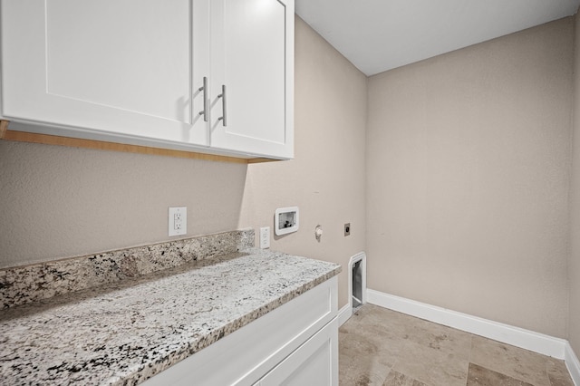 washroom featuring hookup for an electric dryer, cabinets, and hookup for a washing machine