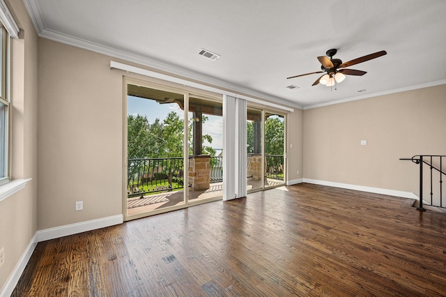 empty room with ceiling fan, dark hardwood / wood-style flooring, and ornamental molding