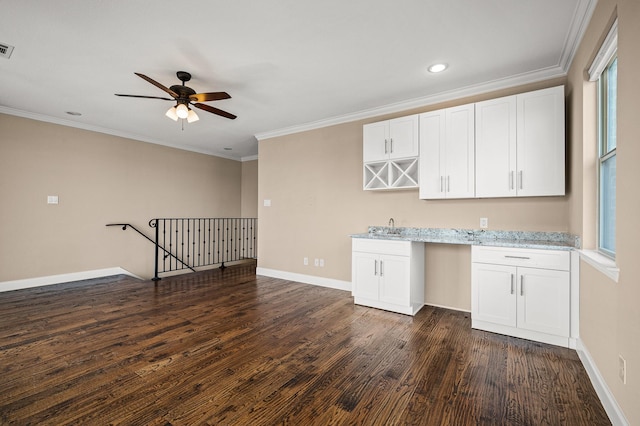 kitchen featuring white cabinetry, ceiling fan, dark hardwood / wood-style floors, and ornamental molding