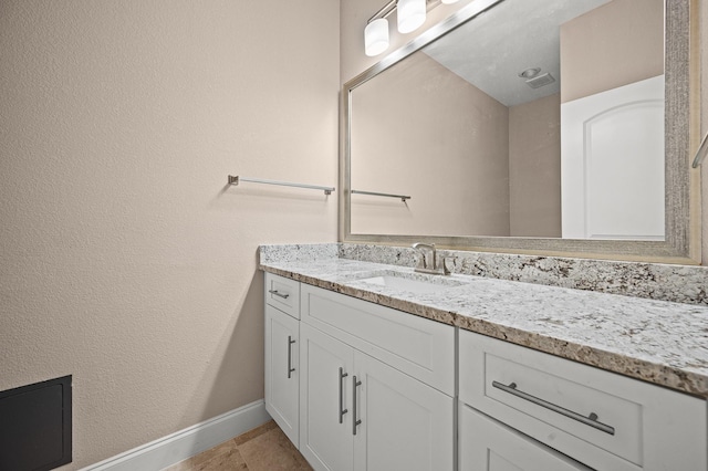 bathroom with tile patterned flooring and vanity