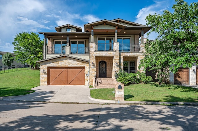 craftsman inspired home featuring a front yard, a balcony, and a garage