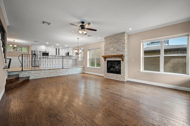 unfurnished living room featuring crown molding, a fireplace, plenty of natural light, and hardwood / wood-style flooring