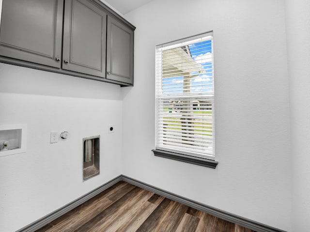 clothes washing area with dark hardwood / wood-style floors, plenty of natural light, and electric dryer hookup