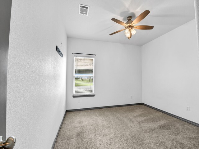 unfurnished room with ceiling fan and carpet flooring