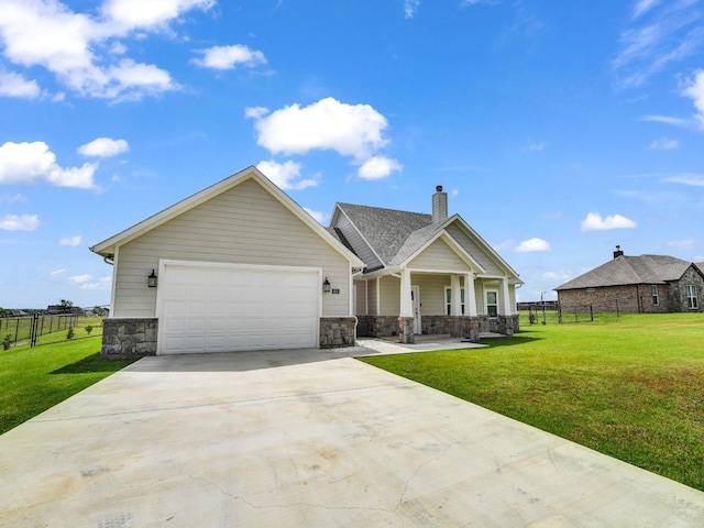 craftsman-style home with a garage, a front yard, and a porch