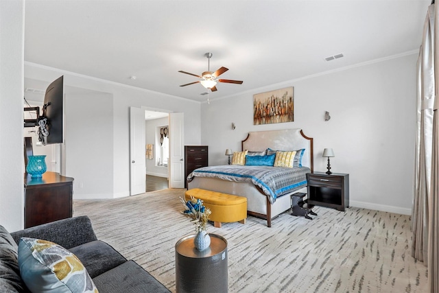 bedroom featuring ceiling fan, light colored carpet, and ornamental molding