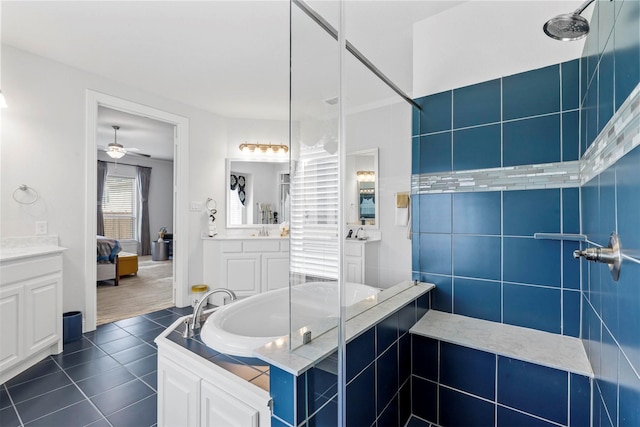 bathroom with tile patterned floors, a ceiling fan, vanity, tiled shower, and ensuite bathroom