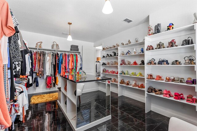 spacious closet featuring granite finish floor and visible vents