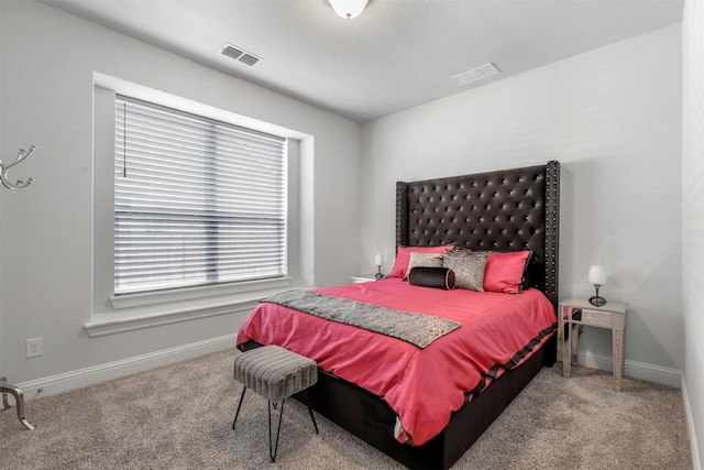 carpeted bedroom with baseboards and visible vents