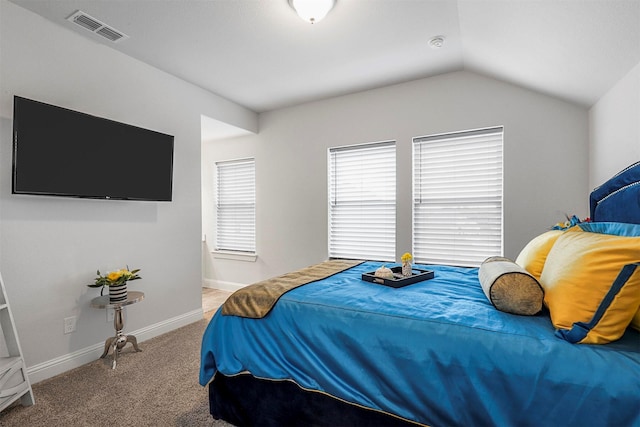 carpeted bedroom featuring lofted ceiling, visible vents, and baseboards