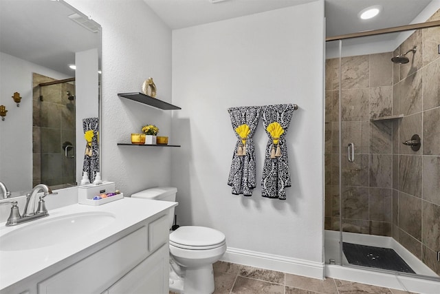 full bathroom featuring toilet, visible vents, baseboards, a shower stall, and vanity