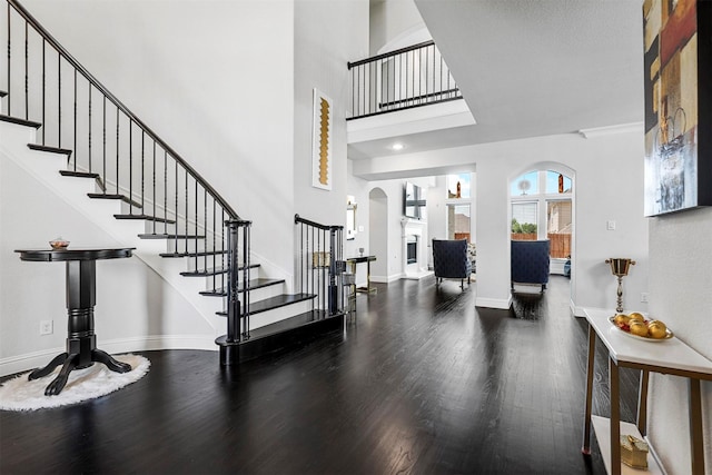 foyer with hardwood / wood-style floors and a high ceiling