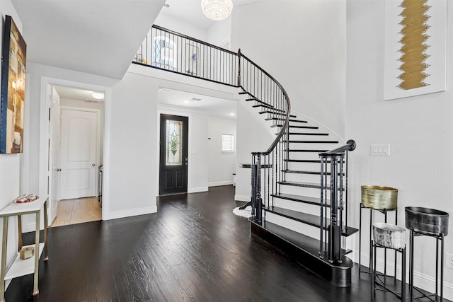 foyer with hardwood / wood-style floors and a high ceiling