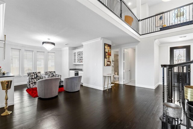 living room featuring dark hardwood / wood-style floors and crown molding