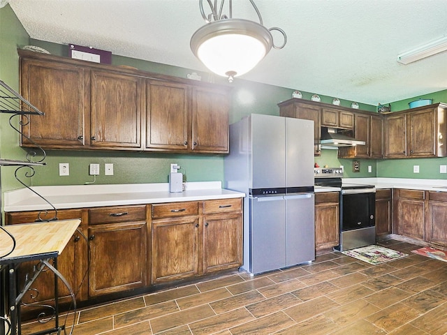 kitchen featuring a textured ceiling and stainless steel appliances