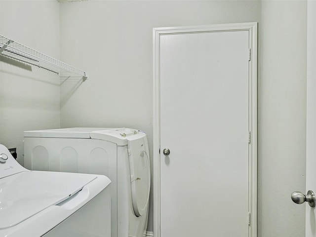 clothes washing area featuring independent washer and dryer