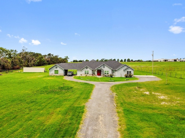 ranch-style home with a rural view and a front lawn