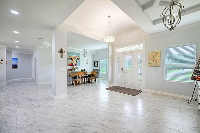 foyer featuring a notable chandelier and ornamental molding