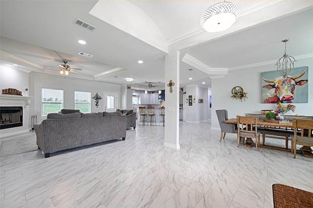 living room featuring ceiling fan and ornamental molding