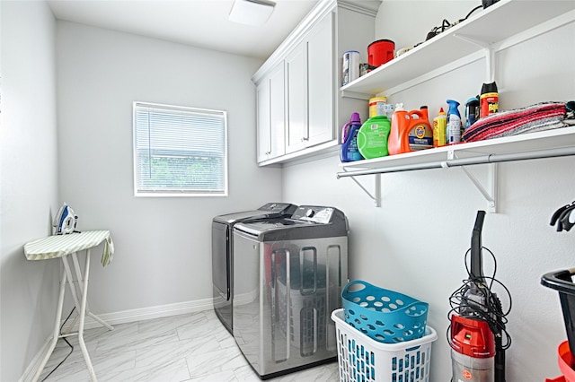 washroom with separate washer and dryer and cabinets