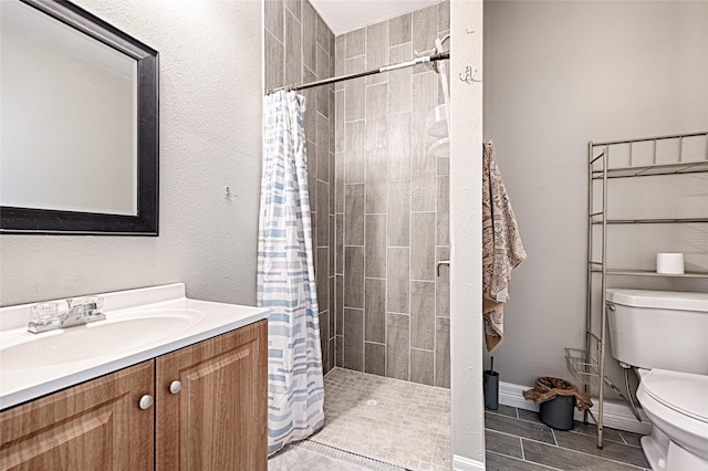 bathroom featuring curtained shower, vanity, and toilet