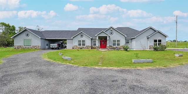 view of front of home with a front lawn and a carport