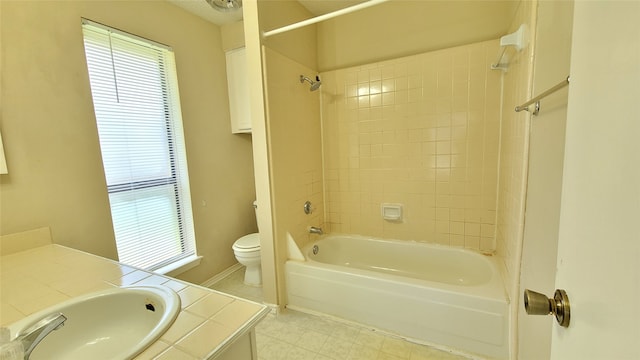 full bathroom featuring tiled shower / bath, tile flooring, toilet, and vanity