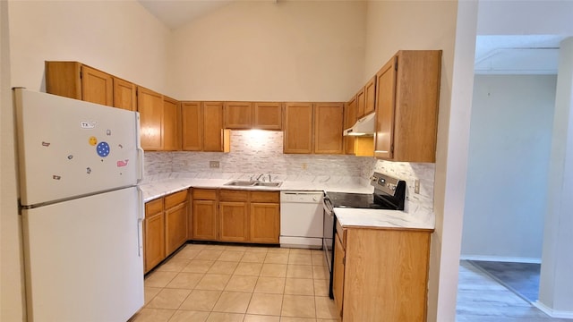 kitchen with high vaulted ceiling, sink, white appliances, and backsplash