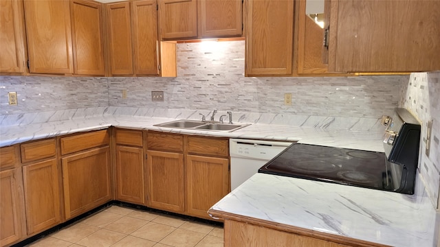 kitchen featuring range, sink, tasteful backsplash, light tile flooring, and dishwasher