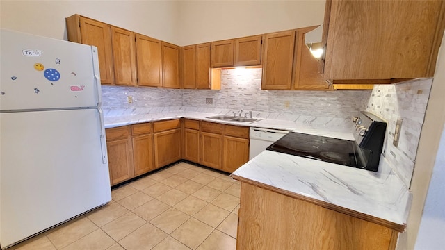 kitchen featuring sink, light tile patterned floors, white appliances, and decorative backsplash