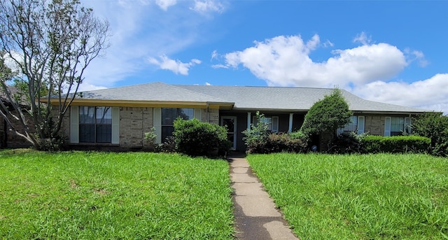 ranch-style home featuring a front yard