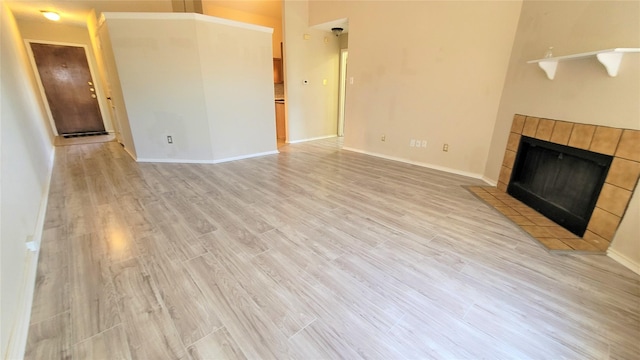 unfurnished living room featuring a fireplace and light hardwood / wood-style flooring