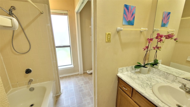 bathroom with tile flooring, vanity, and tiled shower / bath combo