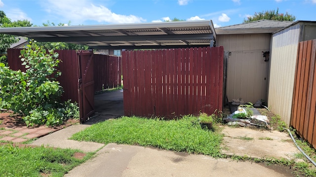 view of yard with a shed and a carport