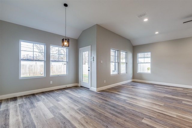 interior space with lofted ceiling and light wood-type flooring