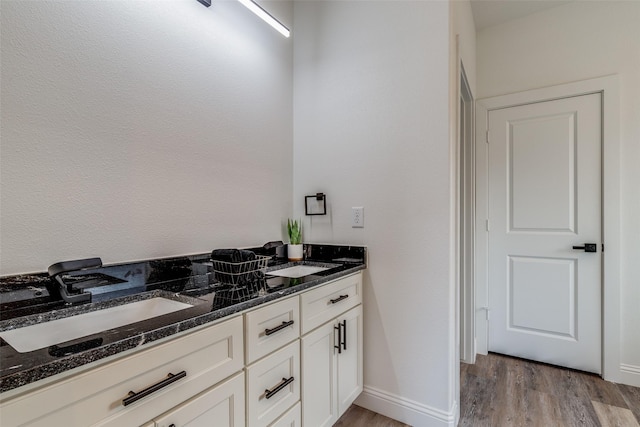 bathroom featuring hardwood / wood-style flooring and vanity