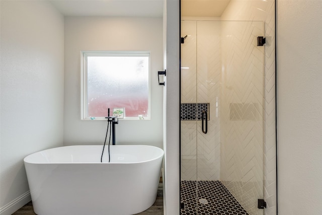 bathroom featuring wood-type flooring and plus walk in shower