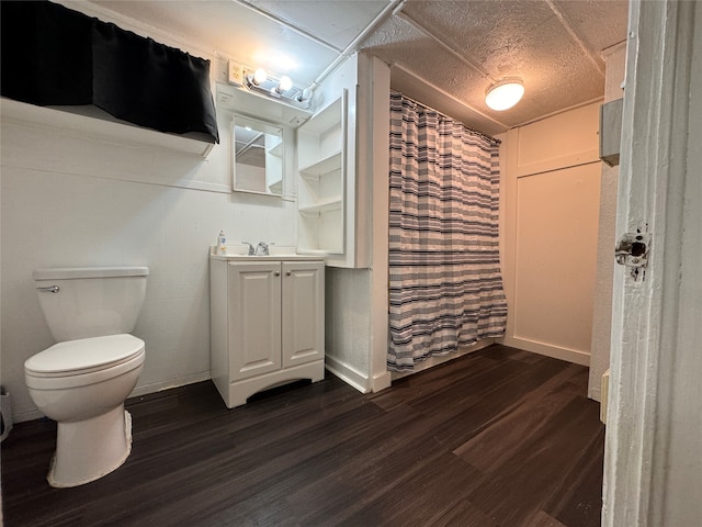 bathroom with vanity, toilet, and hardwood / wood-style flooring