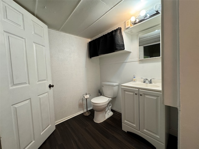 bathroom featuring vanity, toilet, ornamental molding, and hardwood / wood-style floors