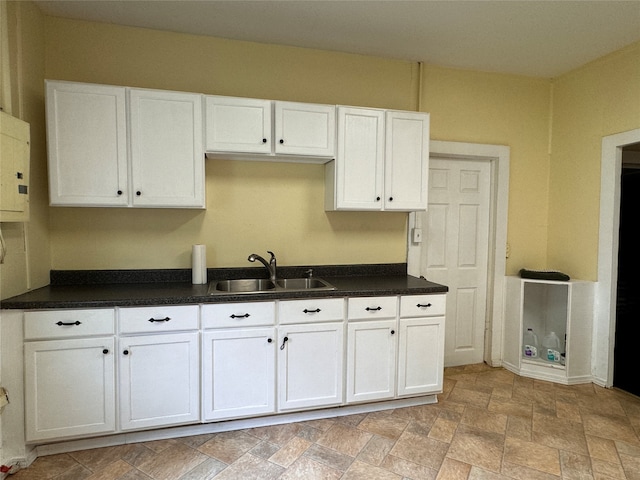 kitchen with white cabinetry and sink