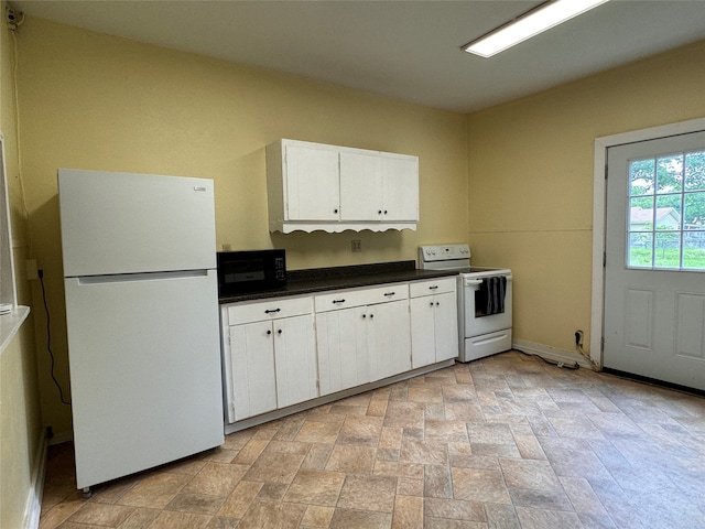 kitchen with white appliances, an AC wall unit, sink, and white cabinets