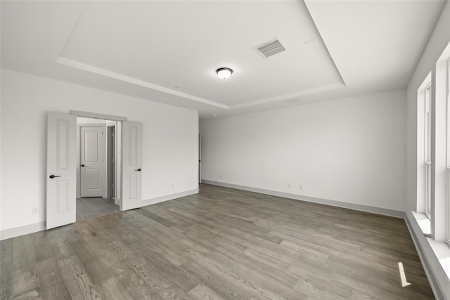 interior space featuring light hardwood / wood-style flooring and a tray ceiling