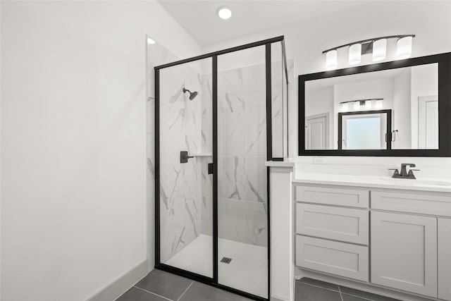 bathroom featuring tile patterned floors, a shower with door, and vanity