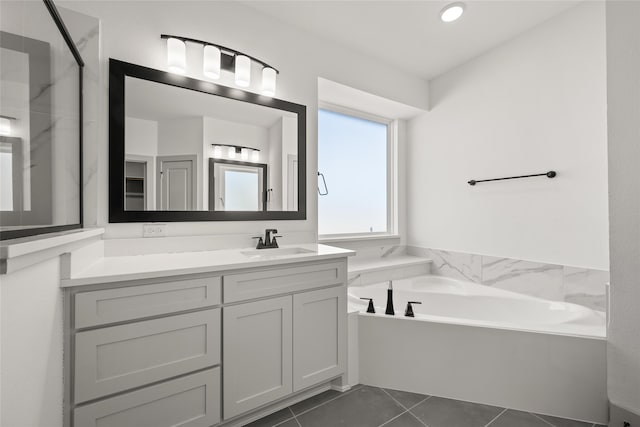 bathroom featuring a washtub, vanity, and tile patterned floors