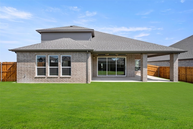 rear view of property featuring a patio and a lawn