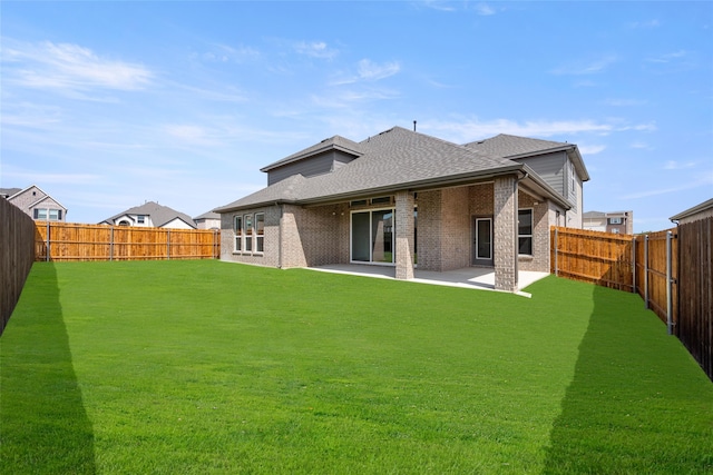 back of house featuring a patio and a lawn